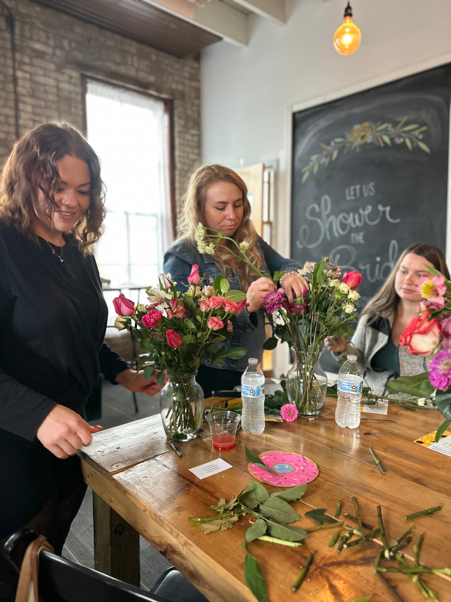 Creating a fresh flower arrangement at a Kansas City self care retreat