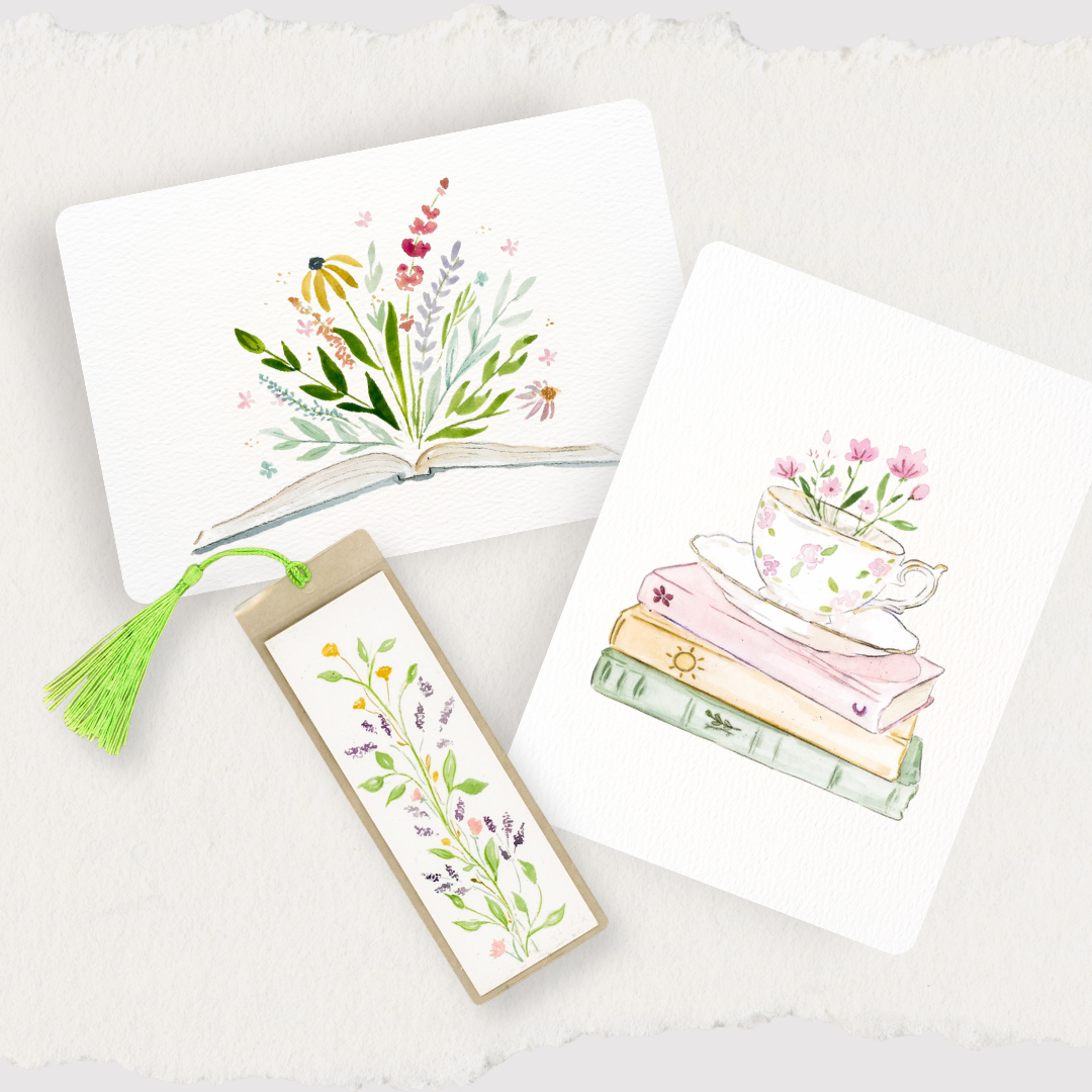 Three watercolor-style bookmarks or card-like stationery pieces arranged on a textured white background: an open book with wildflowers, a stack of books with a teacup and flowers, and a vertical floral bookmark with a green tassel.